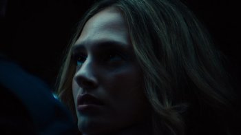 Movie still from “Copenhagen Cowboy” (2022), created by Nicolas Winding Refn – A woman's face in the dark; Close Up shot, Low angle