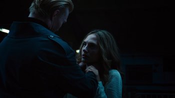 Movie still from “Copenhagen Cowboy” (2022), created by Nicolas Winding Refn – A man and a woman in a dark room; Close Up shot, Over the shoulder angle