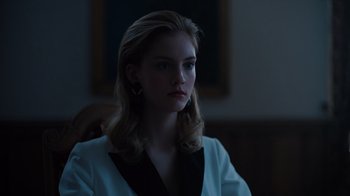 Movie still from “Copenhagen Cowboy” (2022), created by Nicolas Winding Refn – A beautiful young lady with blonde hair wearing a white jacket; Close Up shot, Low angle