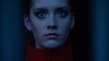 Movie still from “Copenhagen Cowboy” (2022), created by Nicolas Winding Refn – A person with blue eyes; Extreme Close Up shot, Low angle