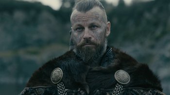 Movie still from “Vikings” (2013), created by Michael Hirst – A person with a beard; Close Up shot, Low angle