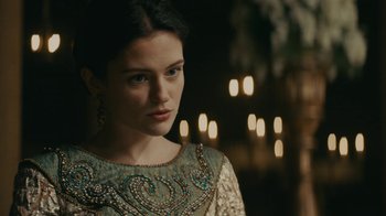 Movie still from “Vikings” (2013), created by Michael Hirst – A beautiful young lady wearing a green and white dress; Close Up shot, Over the shoulder angle