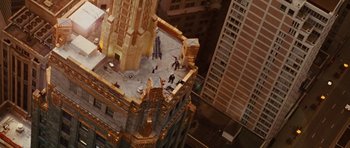 Movie still from “Wanted” (2008), directed by Timur Bekmambetov – An aerial view of a building with people on it; Extreme Wide shot, Overhead angle