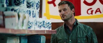 Movie still from “Wanted” (2008), directed by Timur Bekmambetov – A person sitting in front of a shelf of toilet paper; Close Up shot, Over the shoulder angle