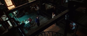 Movie still from “Wanted” (2008), directed by Timur Bekmambetov – A group of people standing in a room; Extreme Wide shot, High angle