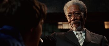 Movie still from “Wanted” (2008), directed by Timur Bekmambetov – An older man in a suit and tie talking to a young man; Close Up shot, Over the shoulder angle