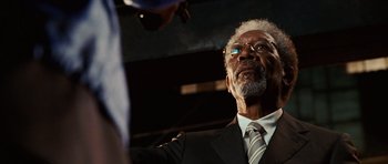 Movie still from “Wanted” (2008), directed by Timur Bekmambetov – An older man wearing a suit and tie; Close Up shot, Low angle