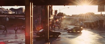 Movie still from “Wanted” (2008), directed by Timur Bekmambetov – A street scene with cars driving on the side of the road; Extreme Wide shot, High angle