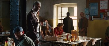 Movie still from “Wanted” (2008), directed by Timur Bekmambetov – A group of people sitting at a table eating food; Medium shot, Over the shoulder angle