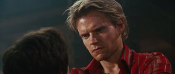 Movie still from “Wanted” (2008), directed by Timur Bekmambetov – A person wearing a red shirt; Close Up shot, Over the shoulder angle