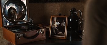 Movie still from “Wanted” (2008), directed by Timur Bekmambetov – An old photo of three men standing in front of an old camera; Medium shot, High angle