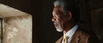 Movie still from “Wanted” (2008), directed by Timur Bekmambetov – An older man wearing a suit and tie looking to his left; Close Up shot, Low angle