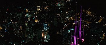 Movie still from “Wanted” (2008), directed by Timur Bekmambetov – An aerial view of a city at night with lights; Extreme Wide shot, High angle