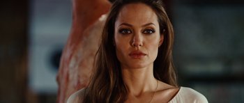 Movie still from “Wanted” (2008), directed by Timur Bekmambetov – A woman with long brown hair wearing a white top; Close Up shot, Over the shoulder angle