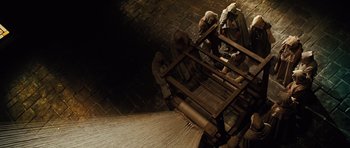Movie still from “Wanted” (2008), directed by Timur Bekmambetov – A group of men working on a machine; Wide shot, High angle