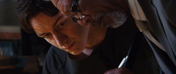 Movie still from “Wanted” (2008), directed by Timur Bekmambetov – A young man getting his hair cut by an older man; Close Up shot, Over the shoulder angle