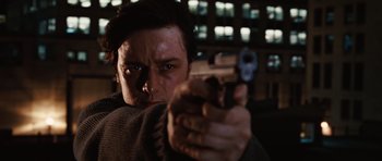 Movie still from “Wanted” (2008), directed by Timur Bekmambetov – A man holding a gun in his hand; Close Up shot, Low angle