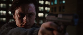 Movie still from “Wanted” (2008), directed by Timur Bekmambetov – A person holding a gun; Close Up shot, Low angle