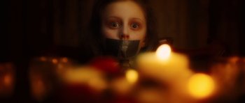Movie still from “Wanted” (2008), directed by Timur Bekmambetov – A young girl with tape over her mouth; Close Up shot, High angle