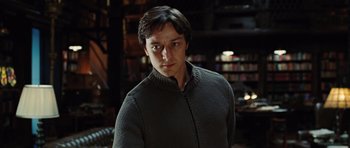 Movie still from “Wanted” (2008), directed by Timur Bekmambetov – A man in a sweater standing in a room; Close Up shot, Low angle