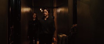 Movie still from “Wanted” (2008), directed by Timur Bekmambetov – A man and a woman standing next to each other in a room; Medium shot, Low angle