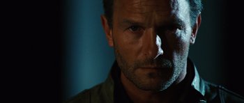 Movie still from “Wanted” (2008), directed by Timur Bekmambetov – A man's face in the dark; Close Up shot, Low angle