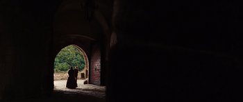 Movie still from “Wanted” (2008), directed by Timur Bekmambetov – Two people are standing in a doorway of an old building; Extreme Wide shot, Low angle