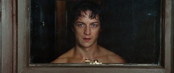 Movie still from “Wanted” (2008), directed by Timur Bekmambetov – A man with blue eyes looking into a mirror; Close Up shot, Over the shoulder angle