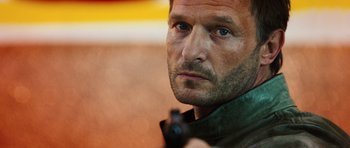 Movie still from “Wanted” (2008), directed by Timur Bekmambetov – A person holding a gun; Close Up shot, Low angle