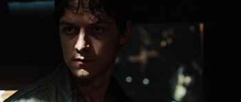 Movie still from “Wanted” (2008), directed by Timur Bekmambetov – A man's face in the dark; Close Up shot, Low angle