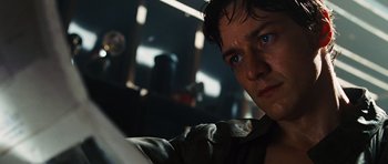 Movie still from “Wanted” (2008), directed by Timur Bekmambetov – A man's face in a dark room; Close Up shot, Low angle