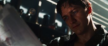 Movie still from “Wanted” (2008), directed by Timur Bekmambetov – A man's face in a dark room; Close Up shot, Low angle