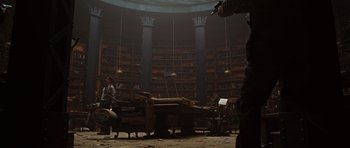Movie still from “Wanted” (2008), directed by Timur Bekmambetov – A room filled with lots of books and furniture; Wide shot, Low angle