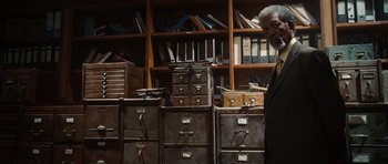 Movie still from “Wanted” (2008), directed by Timur Bekmambetov – A man standing in front of a bunch of filing cabinets; Medium shot, Low angle