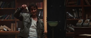 Movie still from “Wanted” (2008), directed by Timur Bekmambetov – A man standing in front of a sink in a room; Medium shot, Low angle