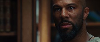 Movie still from “Wanted” (2008), directed by Timur Bekmambetov – A person with a beard looking at the camera; Close Up shot, Low angle