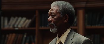 Movie still from “Wanted” (2008), directed by Timur Bekmambetov – An older man wearing a suit and tie; Close Up shot, Over the shoulder angle