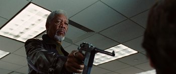 Movie still from “Wanted” (2008), directed by Timur Bekmambetov – An older man is holding a gun in a room; Close Up shot, Low angle