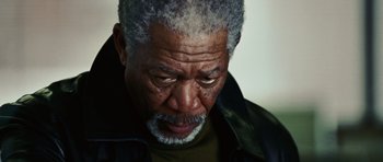 Movie still from “Wanted” (2008), directed by Timur Bekmambetov – An older man with grey hair is looking down; Close Up shot, Low angle