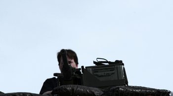 Movie still from “Z Nation” (2014), created by Karl Schaefer – A man standing next to an old television set; Medium shot, Low angle