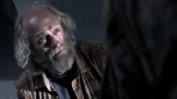 Movie still from “Z Nation” (2014), created by Karl Schaefer – An old man with a beard and a plaid shirt; Close Up shot, Over the shoulder angle