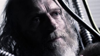 Movie still from “Z Nation” (2014), created by Karl Schaefer – A man with a long white beard looking into the distance; Close Up shot, Low angle