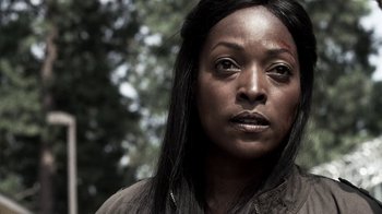 Movie still from “Z Nation” (2014), created by Karl Schaefer – A person with a knife in her mouth; Close Up shot, Low angle