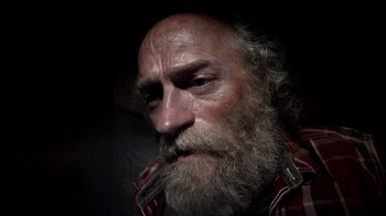 Movie still from “Z Nation” (2014), created by Karl Schaefer – An old man with a long white beard; Close Up shot, Low angle