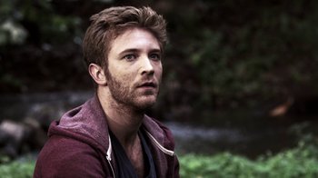 Movie still from “Z Nation” (2014), created by Karl Schaefer – A person wearing a jacket; Close Up shot, Over the shoulder angle