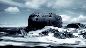 Movie still from “Z Nation” (2014), created by Karl Schaefer – An abandoned us air force plane sitting on top of the ocean; Extreme Wide shot, Low angle