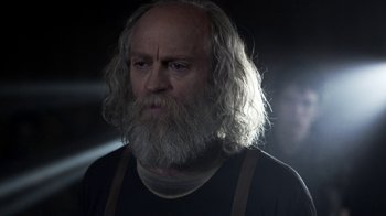 Movie still from “Z Nation” (2014), created by Karl Schaefer – An old man with a long white beard; Close Up shot, Low angle