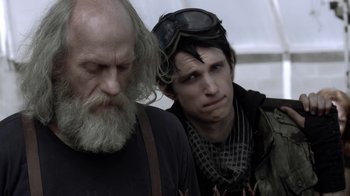 Movie still from “Z Nation” (2014), created by Karl Schaefer – A man and a man with long white beard; Close Up shot, Over the shoulder angle