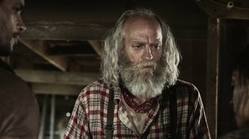 Movie still from “Z Nation” (2014), created by Karl Schaefer – An old man with a long white beard; Close Up shot, Low angle