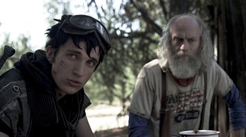 Movie still from “Z Nation” (2014), created by Karl Schaefer – A man and a boy in a forest; Close Up shot, Over the shoulder angle